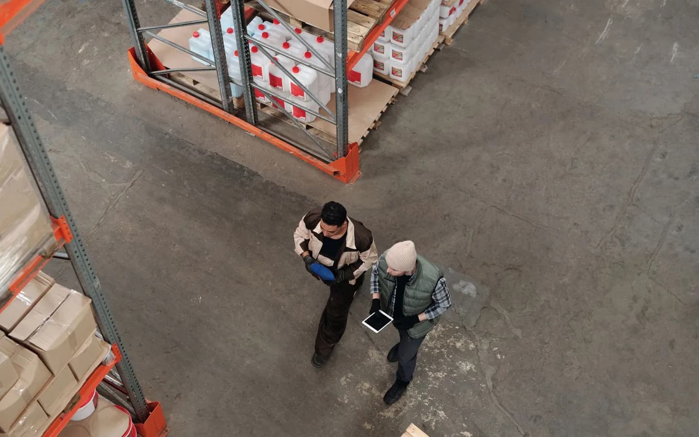 Two warehouse colleagues reviewing inventory together.